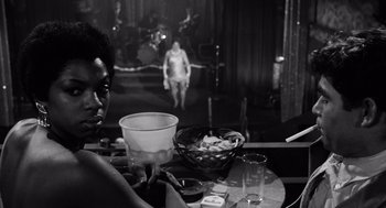 Movie still from “The Pawnbroker” (1964), directed by Sidney Lumet – A person sitting at a table with a bowl of food; Close Up shot, Over the shoulder angle