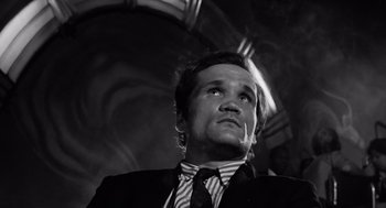Movie still from “The Pawnbroker” (1964), directed by Sidney Lumet – Black and white photograph of a man in a suit looking up; Close Up shot, Low angle