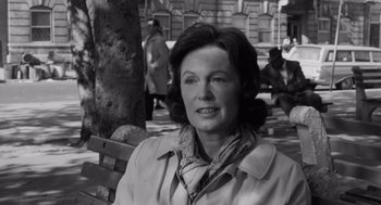 Movie still from “The Pawnbroker” (1964), directed by Sidney Lumet – An older woman sitting on top of a wooden bench; Close Up shot, Over the shoulder angle