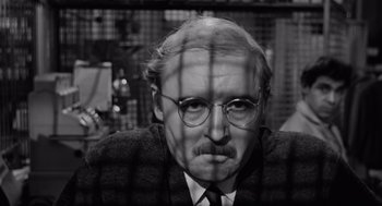 Movie still from “The Pawnbroker” (1964), directed by Sidney Lumet – An older man with a mustache and glasses; Close Up shot, Low angle