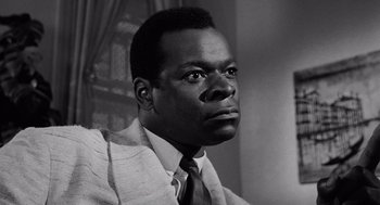 Movie still from “The Pawnbroker” (1964), directed by Sidney Lumet – A black and white photo of a man in a suit and tie; Close Up shot, Low angle