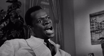 Movie still from “The Pawnbroker” (1964), directed by Sidney Lumet – A black and white photo of a man with his mouth wide open; Close Up shot, Low angle