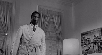 Movie still from “The Pawnbroker” (1964), directed by Sidney Lumet – A black and white photo of a man in a robe; Medium shot, Low angle