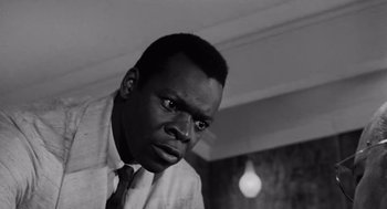 Movie still from “The Pawnbroker” (1964), directed by Sidney Lumet – A black and white photo of a man in a tie; Close Up shot, Low angle