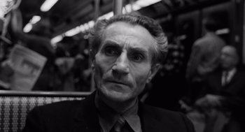 Movie still from “The Pawnbroker” (1964), directed by Sidney Lumet – An older man in a suit and tie looking at the camera; Close Up shot, High angle