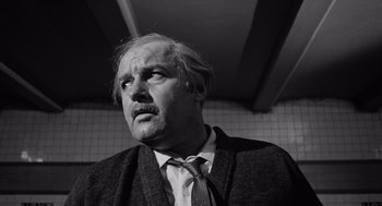 Movie still from “The Pawnbroker” (1964), directed by Sidney Lumet – An older man wearing a suit and tie; Close Up shot, Low angle