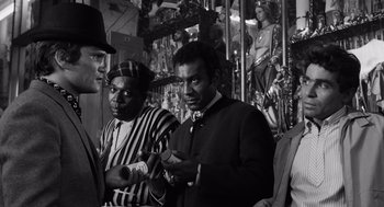 Movie still from “The Pawnbroker” (1964), directed by Sidney Lumet – A black and white photo of a group of people; Medium shot, Over the shoulder angle