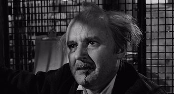 Movie still from “The Pawnbroker” (1964), directed by Sidney Lumet – An older man with a strange look on his face; Close Up shot, Low angle