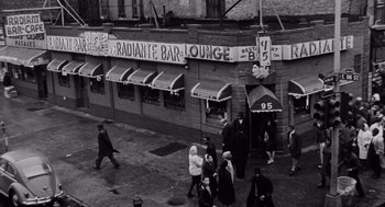 Movie still from “The Pawnbroker” (1964), directed by Sidney Lumet – A black and white photo of people walking on the sidewalk; Extreme Wide shot, High angle