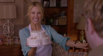 Movie still from “The Perfect Man” (2005), directed by Mark Rosman – A woman holding a cake in her hands; Medium shot, Over the shoulder angle
