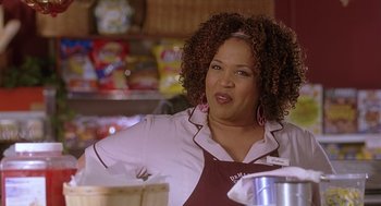 Movie still from “The Perfect Man” (2005), directed by Mark Rosman – A woman with curly brown hair wearing an apron; Close Up shot, Over the shoulder angle