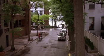 Movie still from “The Perfect Man” (2005), directed by Mark Rosman – A car parked on the side of the road near trees; Extreme Wide shot, High angle