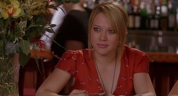 Movie still from “The Perfect Man” (2005), directed by Mark Rosman – A beautiful young lady sitting at a table in a restaurant; Close Up shot, Over the shoulder angle