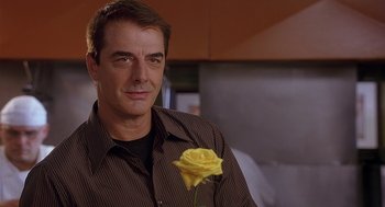 Movie still from “The Perfect Man” (2005), directed by Mark Rosman – A person holding a yellow rose; Close Up shot, Over the shoulder angle