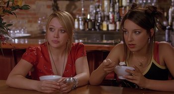 Movie still from “The Perfect Man” (2005), directed by Mark Rosman – Two women sitting at a table with bowls of food in front of them; Close Up shot, Over the shoulder angle