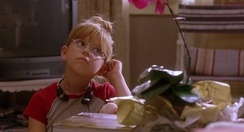 Movie still from “The Perfect Man” (2005), directed by Mark Rosman – A young girl wearing glasses sitting at a table; Close Up shot, High angle