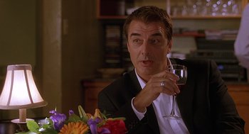 Movie still from “The Perfect Man” (2005), directed by Mark Rosman – A person holding a glass of wine; Close Up shot, Over the shoulder angle