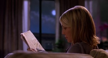 Movie still from “The Perfect Man” (2005), directed by Mark Rosman – A woman sitting in front of a window reading a book; Medium shot, Over the shoulder angle