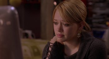 Movie still from “The Perfect Man” (2005), directed by Mark Rosman – A woman sitting on a couch with her hand on her shoulder; Close Up shot, Over the shoulder angle