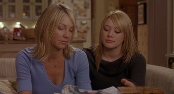 Movie still from “The Perfect Man” (2005), directed by Mark Rosman – Two women sitting at a table looking at a piece of paper; Close Up shot, Over the shoulder angle