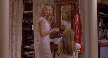 Movie still from “The Perfect Man” (2005), directed by Mark Rosman – A woman in a white dress and a little girl in front of a mirror; Medium shot, Over the shoulder angle