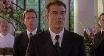 Movie still from “The Perfect Man” (2005), directed by Mark Rosman – A man in a suit and tie standing next to another man in a suit and tie; Close Up shot, Low angle
