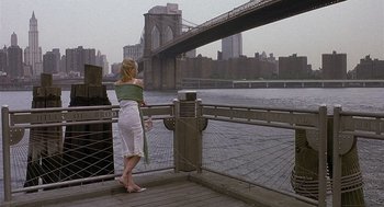 Movie still from “The Perfect Man” (2005), directed by Mark Rosman – A woman standing next to a river with a bridge in the background; Wide shot, High angle