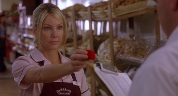 Movie still from “The Perfect Man” (2005), directed by Mark Rosman – A woman holding a tomato in her hand in a store; Close Up shot, Over the shoulder angle