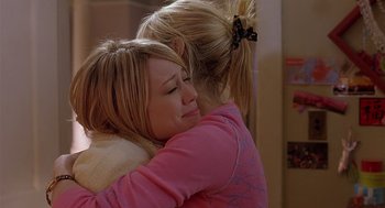 Movie still from “The Perfect Man” (2005), directed by Mark Rosman – A woman hugging another woman in a room; Medium shot, Over the shoulder angle