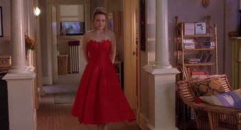 Movie still from “The Perfect Man” (2005), directed by Mark Rosman – A woman in a red dress standing in front of a doorway; Wide shot, High angle