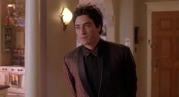 Movie still from “The Perfect Man” (2005), directed by Mark Rosman – A man in a suit and bow tie; Medium shot, Over the shoulder angle