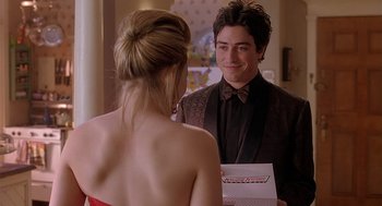 Movie still from “The Perfect Man” (2005), directed by Mark Rosman – A man and a woman holding a box in a room; Medium shot, Over the shoulder angle