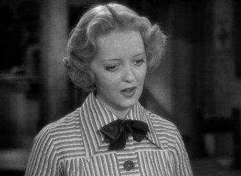 Movie still from “The Petrified Forest” (1936), directed by Archie Mayo – An old photo of a woman in a striped shirt; Close Up shot, High angle