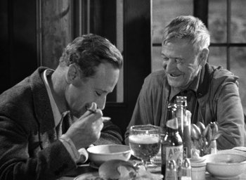 Movie still from “The Petrified Forest” (1936), directed by Archie Mayo – Two men sitting at a dinner table eating soup; Medium shot, Over the shoulder angle
