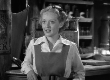 Movie still from “The Petrified Forest” (1936), directed by Archie Mayo – A black and white photo of a woman wearing an apron; Close Up shot, High angle