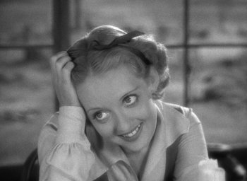 Movie still from “The Petrified Forest” (1936), directed by Archie Mayo – An old photo of a woman smiling for the camera; Close Up shot, High angle