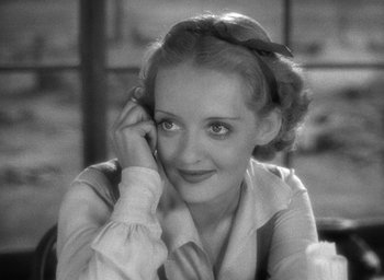 Movie still from “The Petrified Forest” (1936), directed by Archie Mayo – An old photo of a woman with a bow in her hair; Close Up shot, High angle
