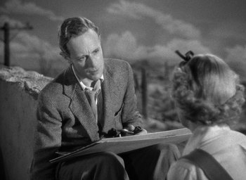 Movie still from “The Petrified Forest” (1936), directed by Archie Mayo – An old photo of a man and a woman sitting on a bench; Medium shot, Over the shoulder angle