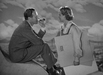 Movie still from “The Petrified Forest” (1936), directed by Archie Mayo – A man and a woman sitting next to each other; Medium shot, Low angle