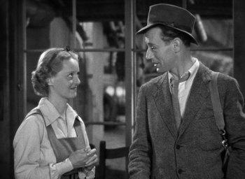 Movie still from “The Petrified Forest” (1936), directed by Archie Mayo – An old photo of a man and a woman talking to each other; Medium shot, Over the shoulder angle