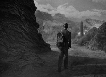 Movie still from “The Petrified Forest” (1936), directed by Archie Mayo – A black and white photo of a man and a child; Extreme Wide shot, High angle