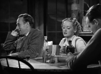 Movie still from “The Petrified Forest” (1936), directed by Archie Mayo – A man and a woman sitting at a table in a restaurant; Medium shot, High angle