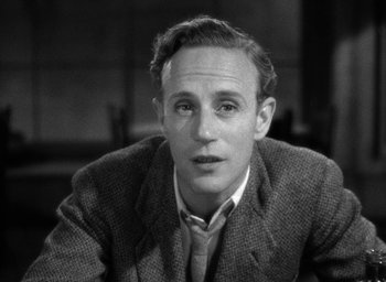 Movie still from “The Petrified Forest” (1936), directed by Archie Mayo – Black and white photograph of a man in a suit and tie; Close Up shot, High angle