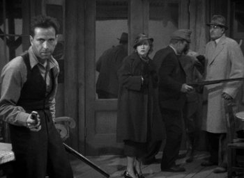 Movie still from “The Petrified Forest” (1936), directed by Archie Mayo – A group of people standing in a room; Medium shot, High angle