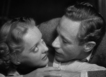 Movie still from “The Petrified Forest” (1936), directed by Archie Mayo – A man and a woman embracing each other in black and white; Close Up shot, High angle
