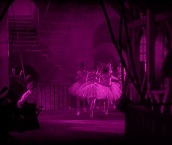 Movie still from “The Phantom of the Opera” (1925), directed by Lon Chaney – A group of ballerinas are dancing in the dark; Extreme Wide shot, High angle