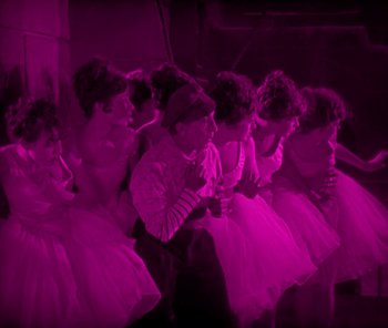 Movie still from “The Phantom of the Opera” (1925), directed by Lon Chaney – A group of young ballerinas in a pink room; Wide shot, High angle