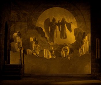 Movie still from “The Phantom of the Opera” (1925), directed by Lon Chaney – A stage lit up with a painting of a scene; Extreme Wide shot, High angle
