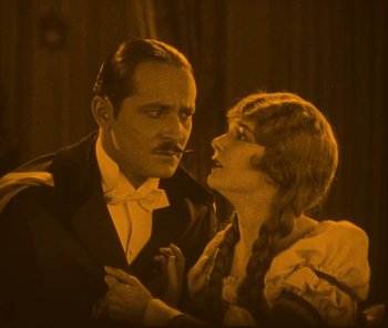 Movie still from “The Phantom of the Opera” (1925), directed by Lon Chaney – A man and a woman are looking at each other; Medium shot, High angle