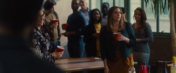 Movie still from “The Photograph” (2020), directed by Stella Meghie – A group of people standing around a table with drinks; Medium shot, Over the shoulder angle